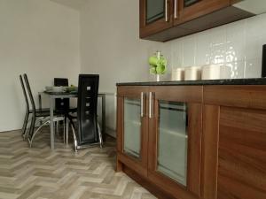a kitchen with a counter and a table with chairs at Earthling 1, Apartment in Blackpool