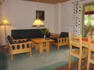 a living room with wooden benches and a table at Ms Monika Rasehorn in Rehefeld-Zaunhaus