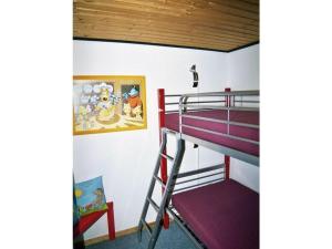 a bedroom with a bunk bed with a ladder and a painting at Strandfleh Modern retreat in Wangerooge