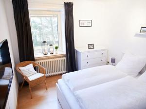 a bedroom with a white bed and a window at The parents' house Modern retreat in Clausthal-Zellerfeld