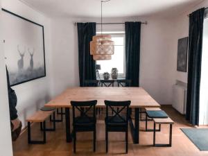 a dining room with a wooden table and chairs at The parents' house Modern retreat in Clausthal-Zellerfeld