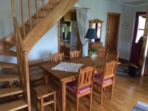 a dining room with a wooden table and chairs at Red-throated diver Modern retreat in Putgarten