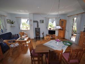 a living room with a table and a dining room at Red-throated diver Modern retreat in Putgarten