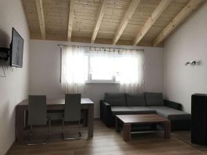 a living room with a couch and a table at Holiday home Baier in Philippsreut