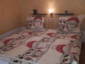 a bed with a group of owls on it at by the forest Modern retreat in Tharandt