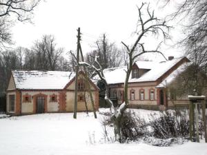 a house with snow on the roof of it at in the estate worker's house 