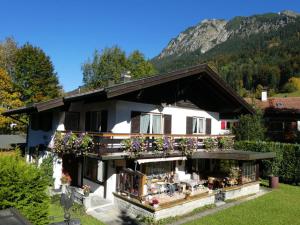 a house with a balcony with flowers on it at Haus Steiner Modern retreat in Oberstdorf