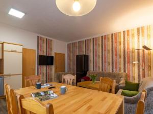 a living room with a wooden table and a dining room at Holiday apartments Ender in Sebnitz