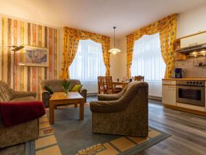 a living room with two couches and a table at Holiday apartments Ender in Sebnitz