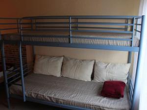 a bunk bed with white pillows and a red pillow at Family idyll Comfortable holiday residence in Kargow