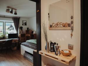a room with a mirror and a bedroom with a bed at Pura Vida - holiday apartment in Fischen
