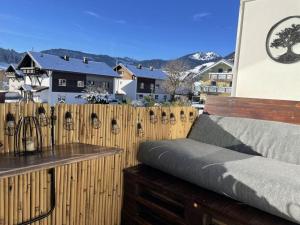 a wooden fence with a bed on a balcony at Pura Vida - holiday apartment in Fischen