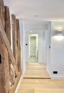 a hallway with wooden flooring and a wall of logs at 1570 - Luxury spot in Paris Olympic Games 2024 in Paris