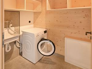 a washer and dryer in a small bathroom at Grandma Ludwin 1 Modern retreat in Sasbachwalden