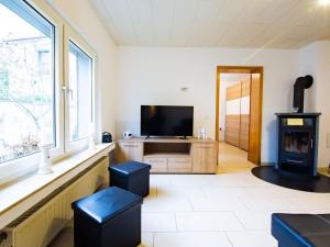 a living room with a tv and a large window at Holiday apartment Alstaden 1 in Oberhausen