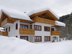 a house with snow on top of it at Partnachklamm Modern retreat in Garmisch-Partenkirchen