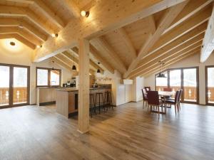 a large kitchen and dining room with wooden ceilings at Partnachklamm Modern retreat in Garmisch-Partenkirchen