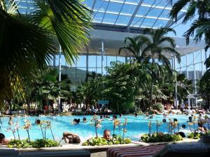 a large swimming pool with people in a resort at Landhuis Appartement Feldberg uitzicht in Sankt Märgen