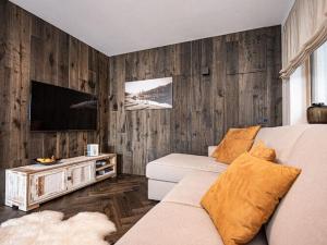 ein Wohnzimmer mit einem Sofa und einem Flachbild-TV in der Unterkunft Holiday apartment in Seis am Schlern in Seis am Schlern