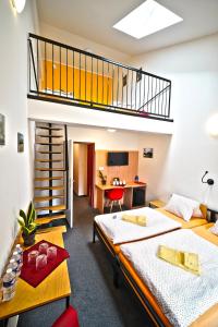two beds in a room with a loft at Wellness hotel Lihovar in Třemošnice