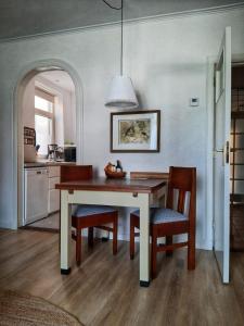 a dining room with a table and two chairs at Logement Hartsuiker in Hoogeveen