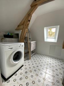 a laundry room with a washer and a window at Logement du Coteau entre Beauval et Amboise in Faverolles-sur-Cher