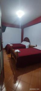a bedroom with two beds in a room at Lhotse Hostel B&B in Huaraz
