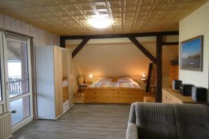 a bedroom with a bed in the corner of a room at FeWo mit Balkon, Zimmermann in Strasen