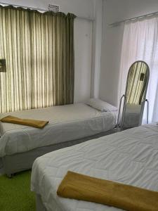 Postel nebo postele na pokoji v ubytování Sunset Guesthouse - Mthatha