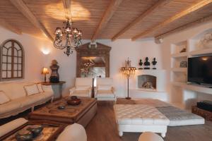 a living room with a couch and a tv at Your Mykonos in Mýkonos City