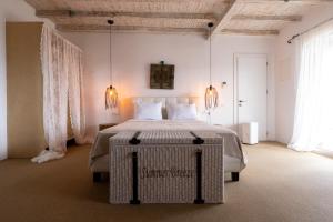 a bedroom with a large bed with a table at Your Mykonos in Mýkonos City