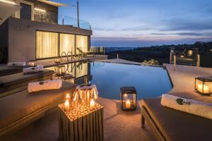 uma villa com uma piscina com velas no pátio em Residence Monte near Umag for 10 people with heated infinity pool & spa 