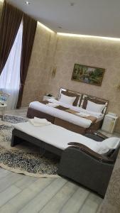 two beds in a hotel room with two bedsskirts at The Afrosiyob Ok in Samarkand