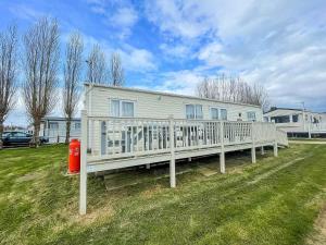 a large white house with a white porch at Lovely Caravan With Decking At Manor Park In Hunstanton Ref 23091t in Hunstanton