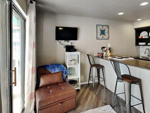 a kitchen with a bar with a chair and a table at Villa Del Sol #2138 in Corpus Christi