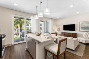 a living room with a kitchen and a living room with a couch at the Pointe Unit 125 in Rosemary Beach