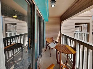 a balcony with two chairs and a table at Villa Del Sol #2138 in Corpus Christi
