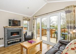 a living room with a couch and a fireplace at Crake Valley in Torver