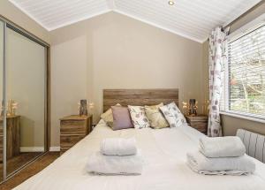 a bedroom with a large white bed with two pillows at Crake Valley in Torver