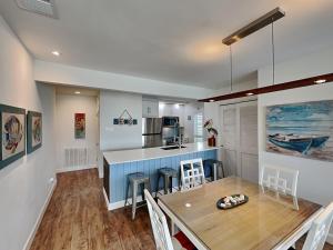 a kitchen and dining room with a table and chairs at Sunset Water View in Padre Island +46 photos
