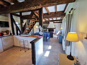 a kitchen and living room with wooden beams at La Bergerie in Cambremer +60 photos