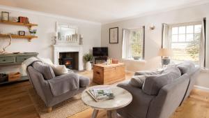 a living room with two couches and a coffee table at The Sheep Cote, Pentland Hills in Nine Mile Burn