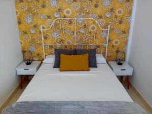 a bedroom with a white bed with a yellow wall at Villa Stefi in Playa Blanca +25 photos
