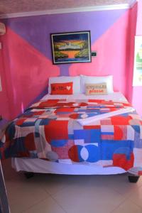 a bedroom with a colorful bed in a room at Magagula's Guest House and Accomodation in Burgersfort