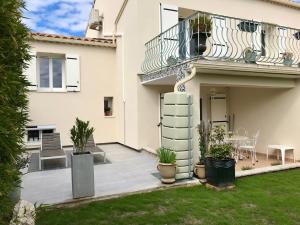 a house with a patio and a balcony at Les 2 Oliviers in Caromb