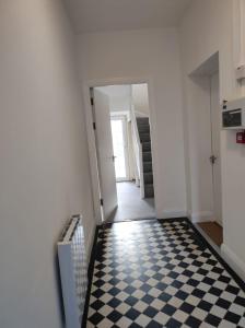 a hallway with a black and white checkered floor at Main Street Swinford! in Swinford