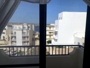 a view from a window of a building at Quiet, Cosy Mellieha Apartment In Ghadira Bay in Mellieħa