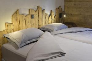 two beds sitting next to each other in a room at La cabane luxury apartment in the heart of the village in La Grave