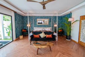 a living room with a couch and a table at La Belle Vie - Boutique Hotel Adults Only in Baan Tai