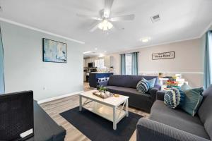 a living room with a couch and a table at Beach Bella-Quiet 3BR-3 Min to the Beach in Destin